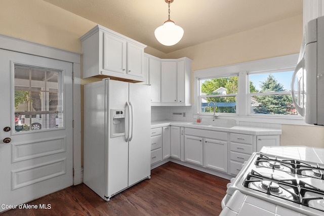 kitchen with sink, dark hardwood / wood-style flooring, white cabinets, and white appliances