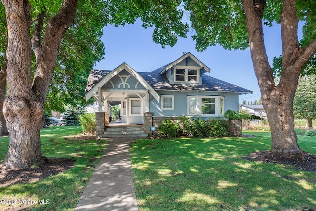 craftsman-style home with covered porch and a front lawn