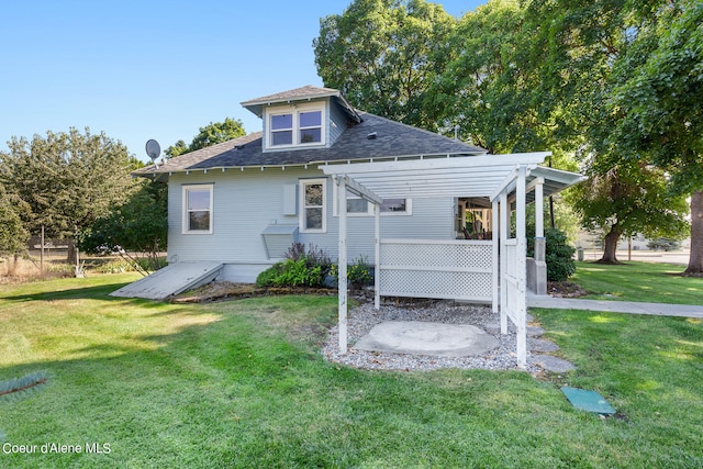 rear view of property featuring a yard