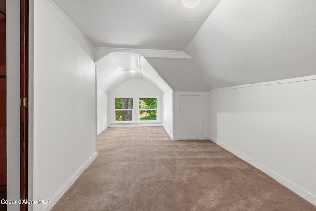 bonus room featuring light carpet and lofted ceiling