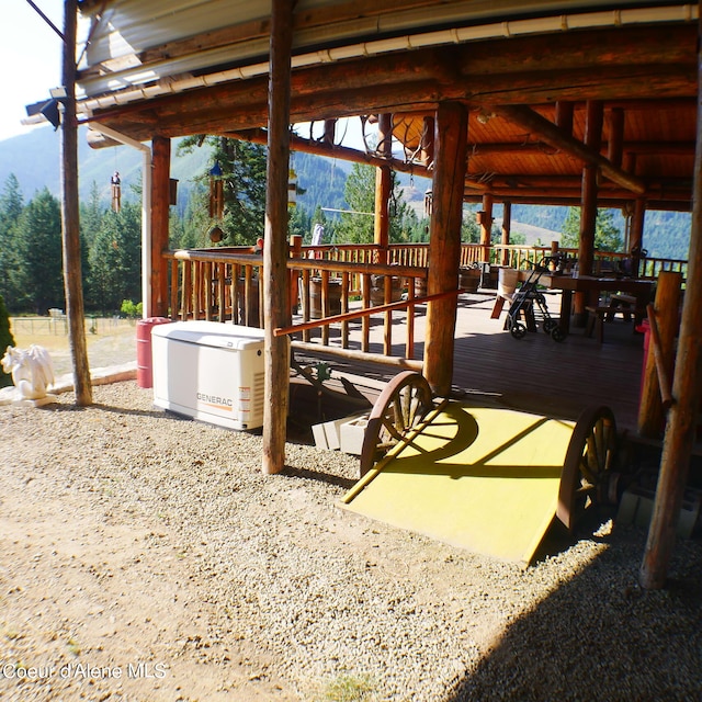 view of patio / terrace with a deck with mountain view