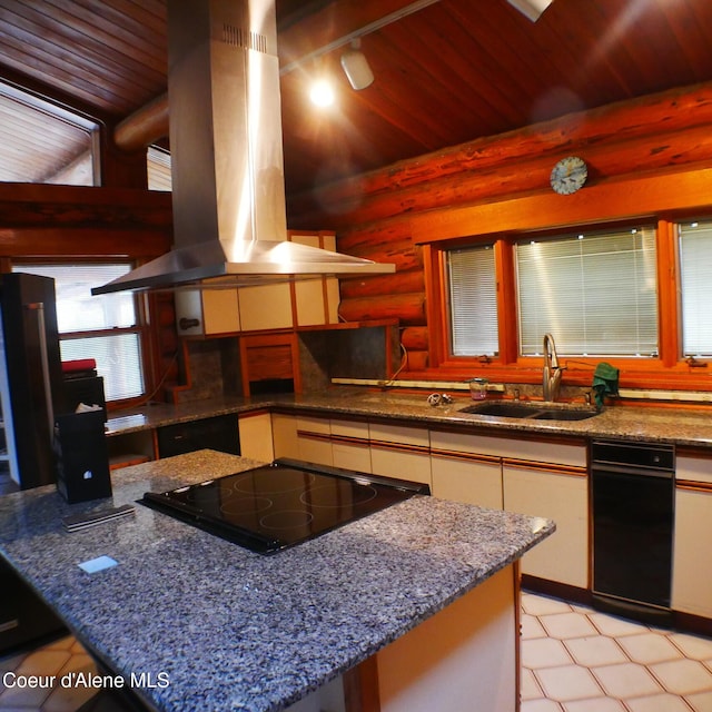 kitchen featuring sink, dark stone countertops, black electric cooktop, log walls, and island range hood