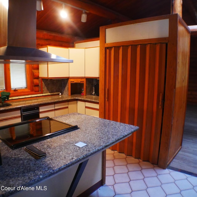 kitchen featuring tasteful backsplash, cooktop, ventilation hood, white cabinetry, and oven