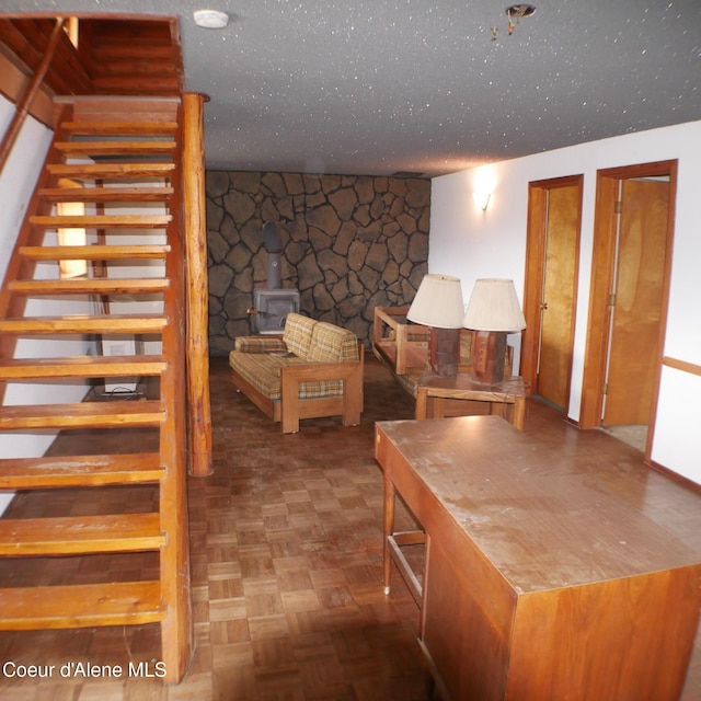 interior space featuring a wood stove and parquet floors