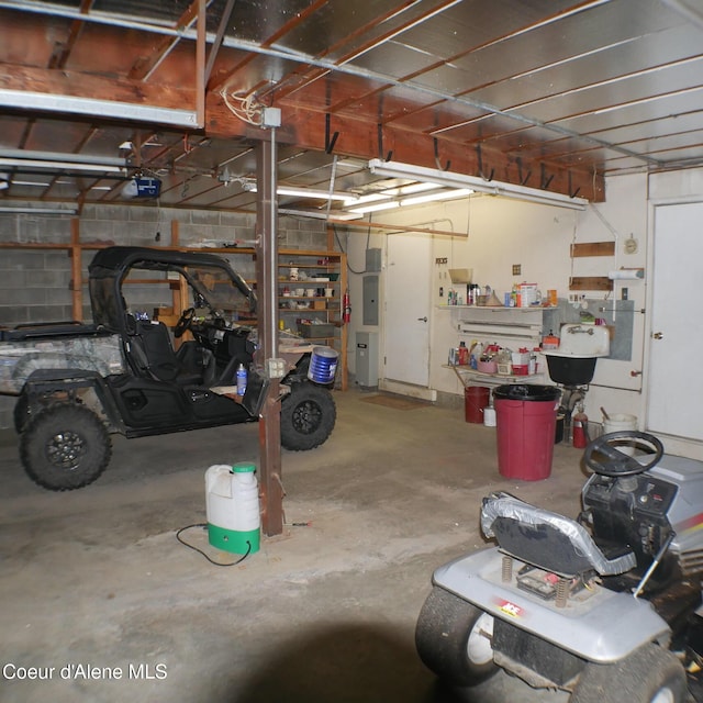 garage with electric panel and a garage door opener