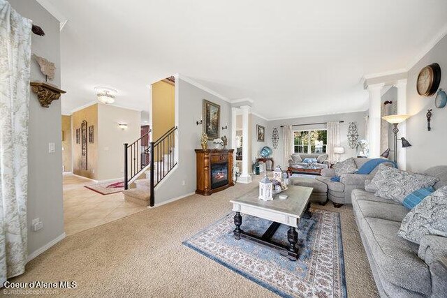 carpeted living room with tile patterned floors, stairway, a glass covered fireplace, and baseboards