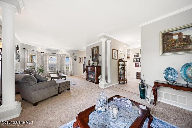 carpeted living room featuring visible vents, decorative columns, crown molding, and baseboards
