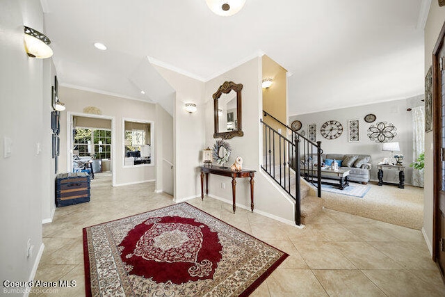 entrance foyer with light tile patterned flooring and ornamental molding