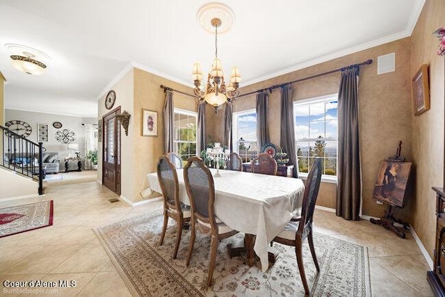 dining space with light tile patterned floors, crown molding, stairway, a chandelier, and baseboards