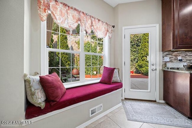 doorway to outside featuring light tile patterned floors, visible vents, and plenty of natural light