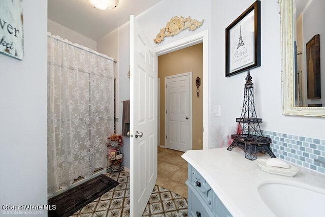 bathroom with tile patterned floors, a shower with shower curtain, and vanity