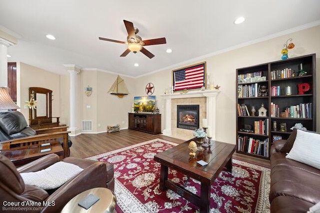 living room featuring recessed lighting, a premium fireplace, a ceiling fan, visible vents, and ornate columns