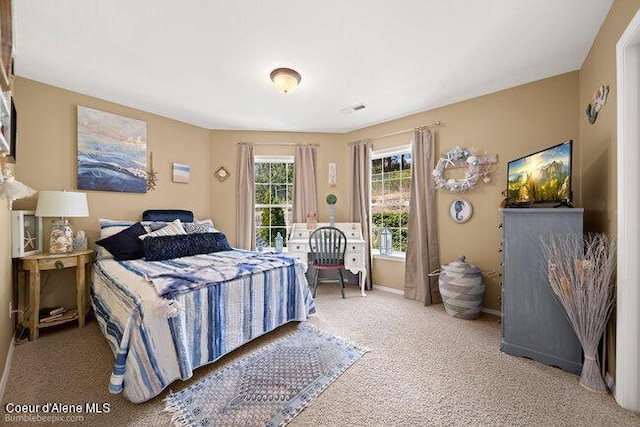 bedroom with visible vents, carpet flooring, and baseboards