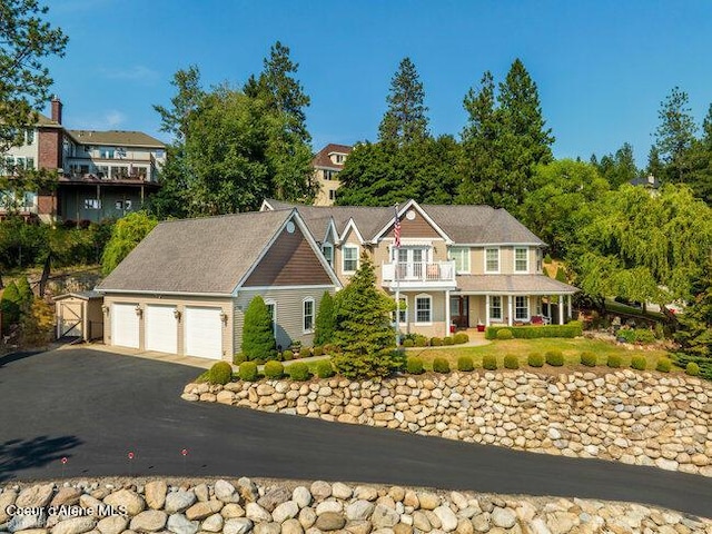 view of front of home featuring a gate, a balcony, and a garage