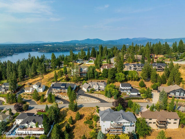 birds eye view of property with a water and mountain view