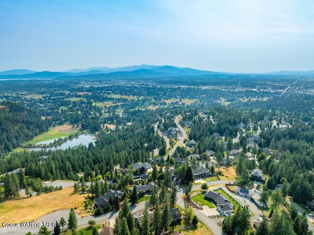 bird's eye view with a water and mountain view and a forest view