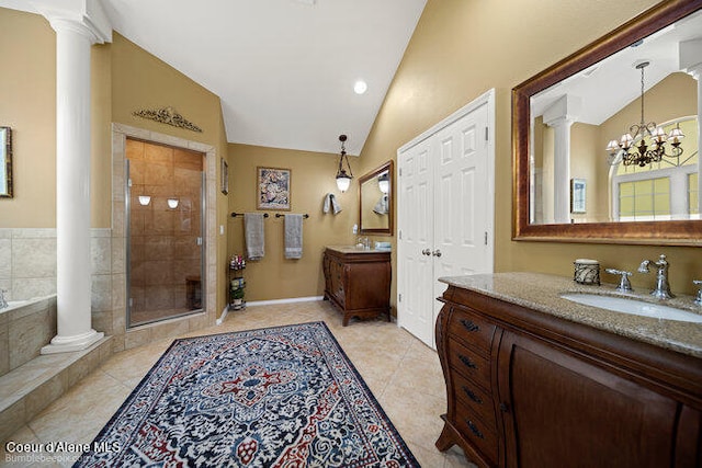 bathroom with an inviting chandelier, tile patterned floors, vanity, and separate shower and tub