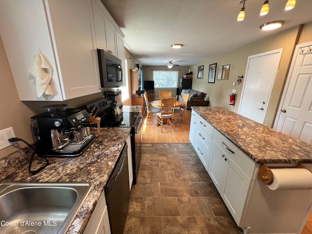 kitchen featuring open floor plan, white cabinets, and appliances with stainless steel finishes