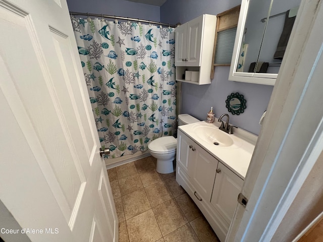 bathroom featuring tile patterned flooring, toilet, vanity, and a shower with curtain