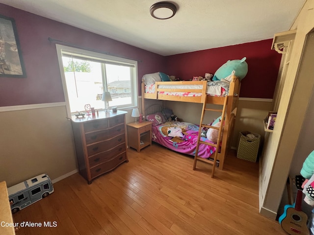 bedroom featuring light wood-type flooring and baseboards