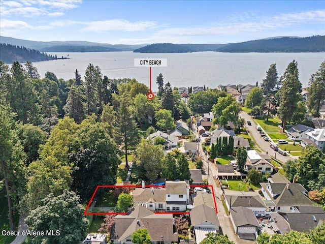 drone / aerial view featuring a water and mountain view