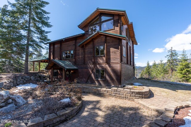 back of property featuring a patio area