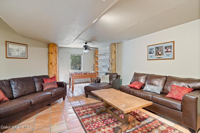 tiled living room featuring ceiling fan and a textured ceiling