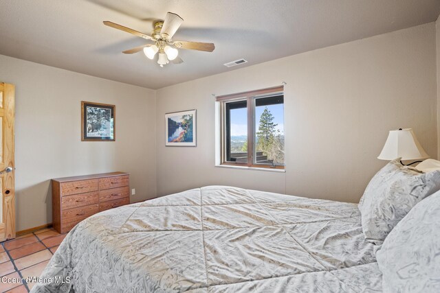 bedroom featuring light tile patterned floors and ceiling fan