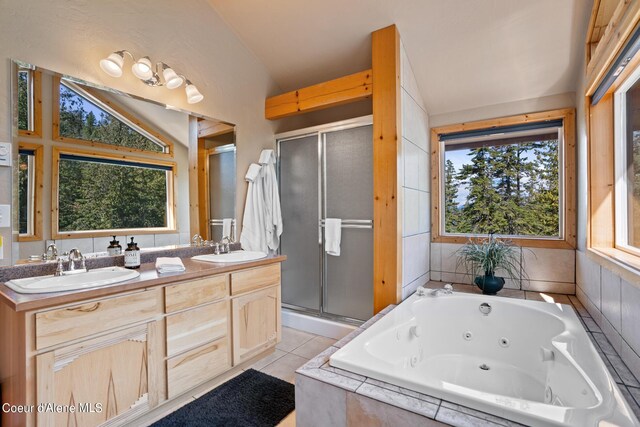 bathroom featuring independent shower and bath, vaulted ceiling, and a healthy amount of sunlight