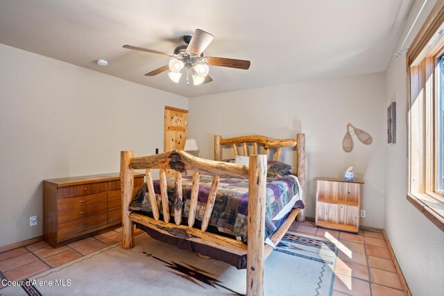 tiled bedroom with ceiling fan