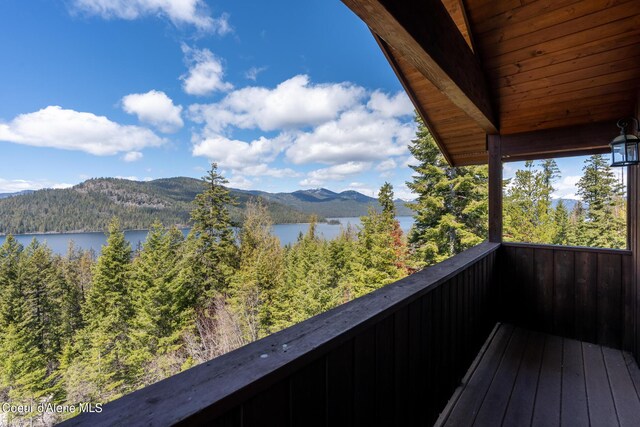 balcony featuring a water and mountain view