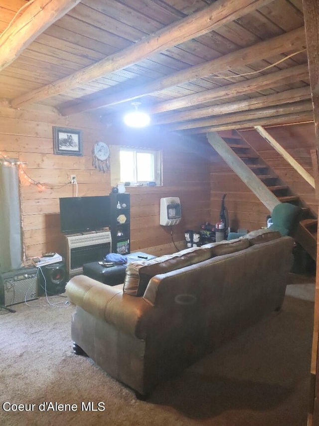 carpeted living room featuring beam ceiling, wood walls, and wood ceiling