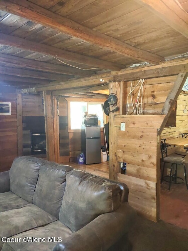 living room with wood walls, beamed ceiling, and wood ceiling