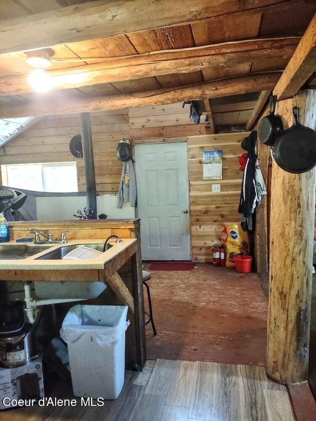 interior space featuring wooden walls, a workshop area, and hardwood / wood-style floors