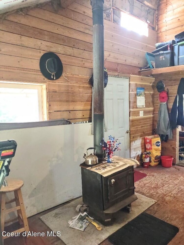 interior space with wood walls and a wood stove