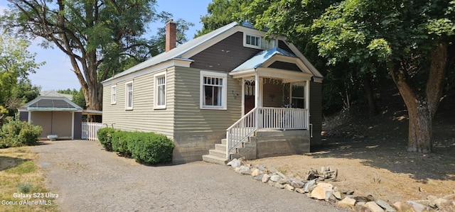 view of front facade with a storage shed and covered porch