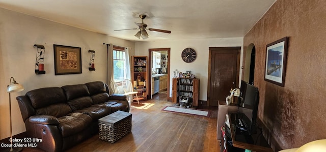 living room with ceiling fan and hardwood / wood-style flooring