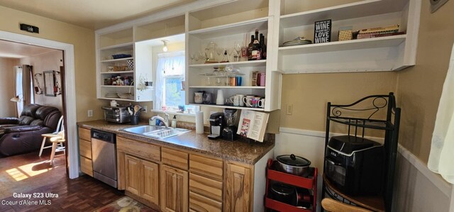 interior space featuring dark parquet floors, sink, and stainless steel dishwasher