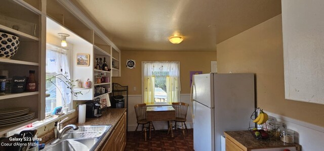 kitchen with sink, dark parquet flooring, and white fridge