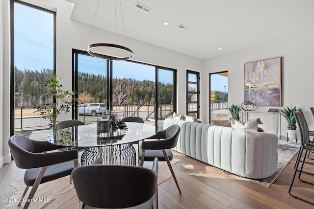 dining space with visible vents, wood finished floors, and recessed lighting