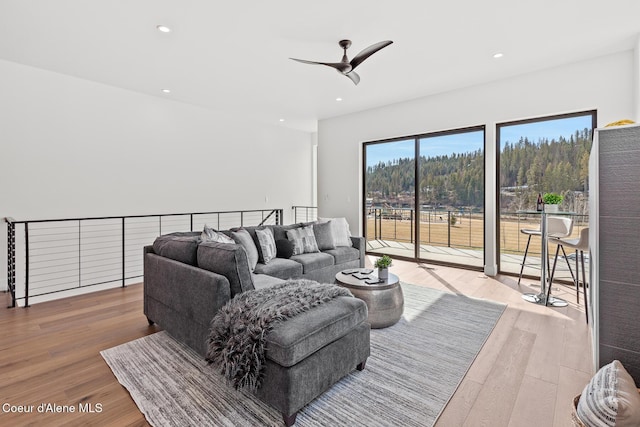 living area featuring wood finished floors, a ceiling fan, and recessed lighting