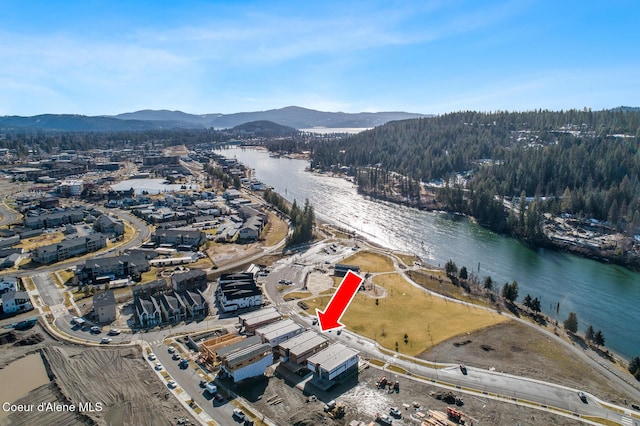 bird's eye view featuring a water and mountain view and a view of trees