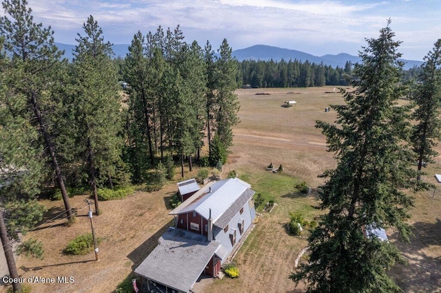 drone / aerial view with a mountain view and a forest view