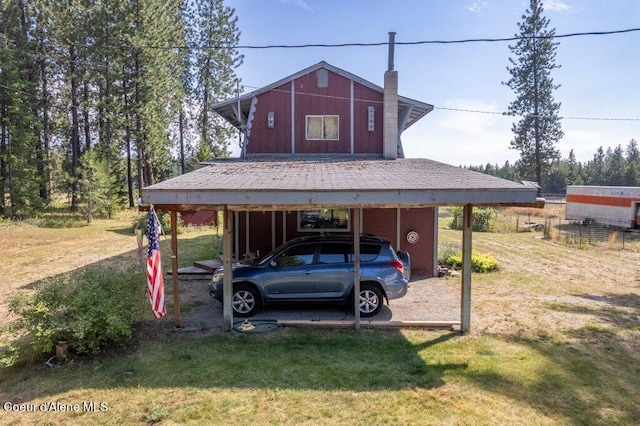 view of vehicle parking featuring a lawn