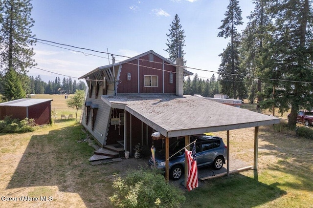 exterior space with a yard and a carport