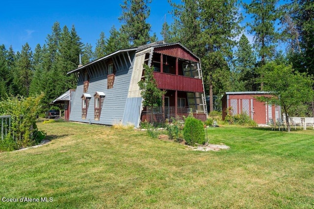 exterior space with a balcony and a yard