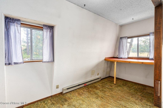 interior space with dark carpet, a textured ceiling, and baseboard heating