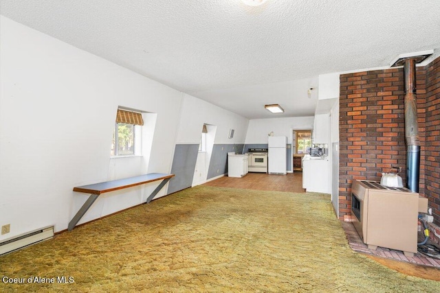 unfurnished living room with a textured ceiling, dark colored carpet, a baseboard heating unit, and a wood stove