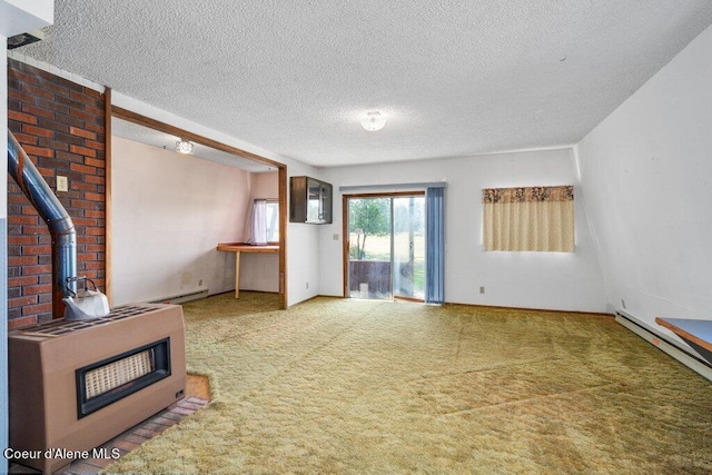 unfurnished living room with a baseboard heating unit, heating unit, a textured ceiling, carpet flooring, and a wood stove