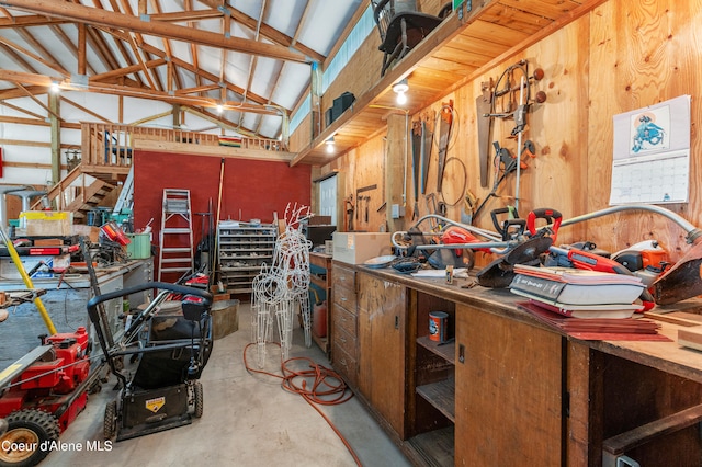 garage with wooden walls and a workshop area